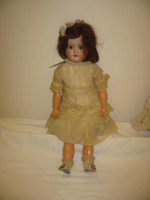 Appraisal: A Schoenau and Hoffmeister bisque head doll with blue sleeping