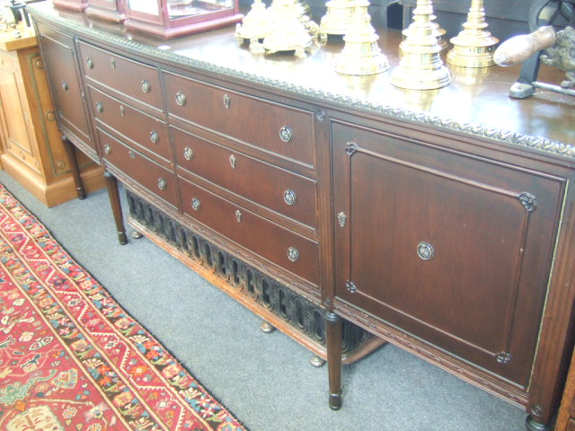 Appraisal: A th century mahogany bowfront sideboard with an arrangement of