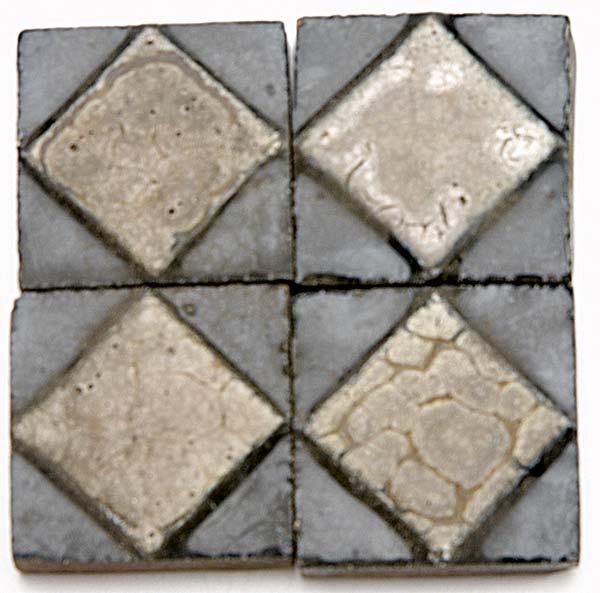 Appraisal: GRUEBY Forty tiles with ivory diamond design on a glossy