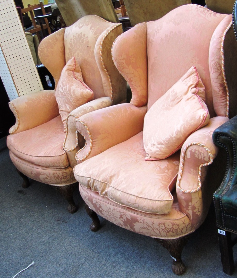 Appraisal: A pair of George V walnut and parcel gilt wingback