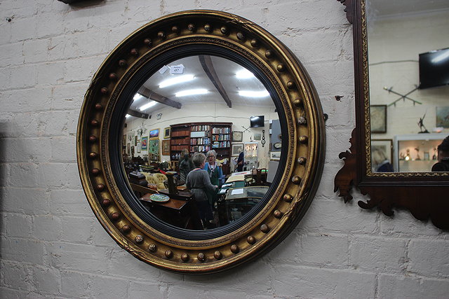 Appraisal: A REGENCY STYLE GILT FRAMED CIRCULAR CONVEX WALL MIRROR with