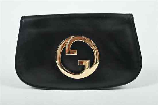 Appraisal: GUCCI BLACK LEATHER CLUTCH The fold-over flap with cut-out gold-tone