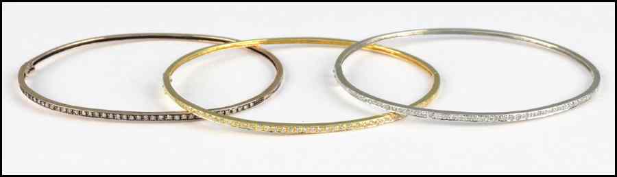 Appraisal: THREE KARAT GOLD AND DIAMOND BANGLES Yellow white and rose