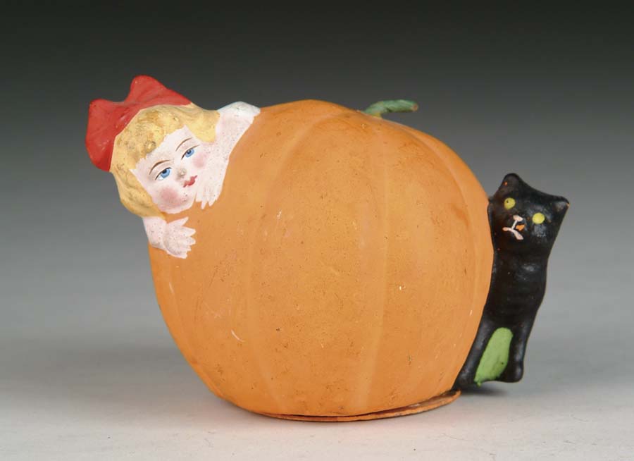 Appraisal: UNUSUAL GERMAN PUMPKIN CANDY CONTAINER Halloween candy container shows girl