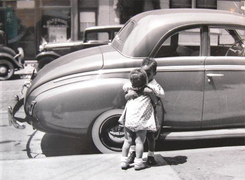 Appraisal: Two Children Hugging Mother Sewing while Young Boy and Two