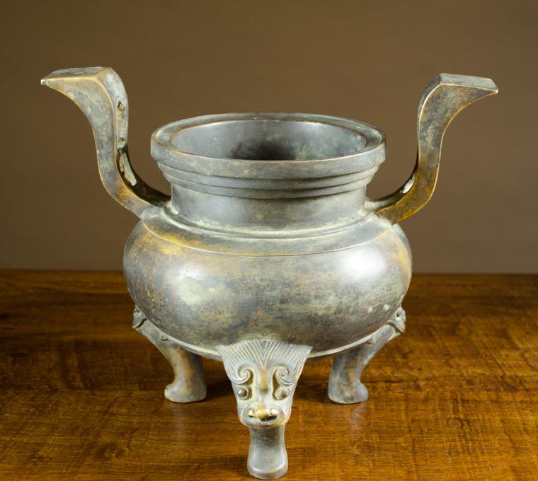 Appraisal: CHINESE BRONZE CENSER tri-footed with raised split handles Height inches