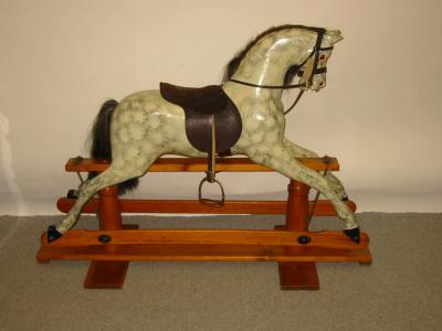 Appraisal: A late th century carved wood and painted rocking horse