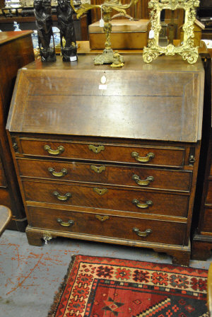 Appraisal: A Georgian oak bureau the sloping fall front enclosing drawers