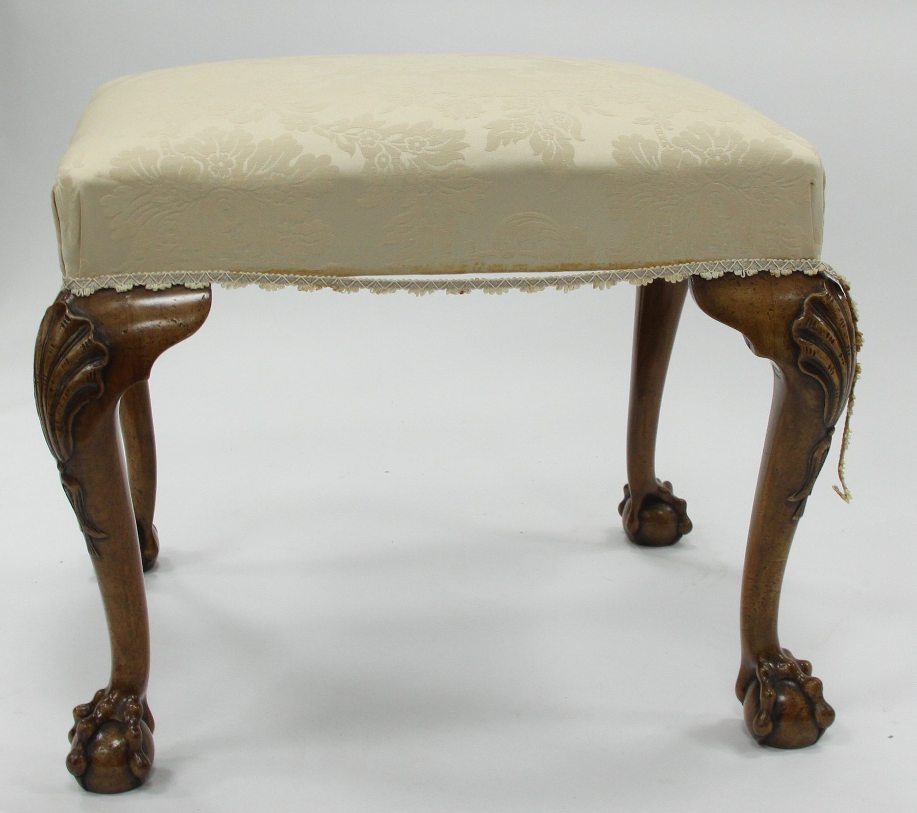 Appraisal: A walnut stool with upholstered top the cabriole legs carved