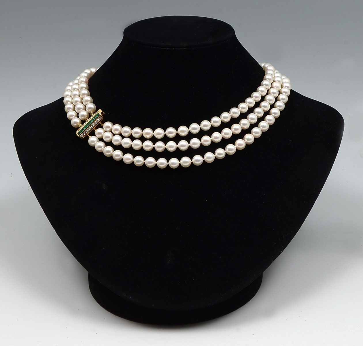 Appraisal: STRAND PEARL NECKLACE WITH K DIAMOND EMERALD CLASP Triple strand