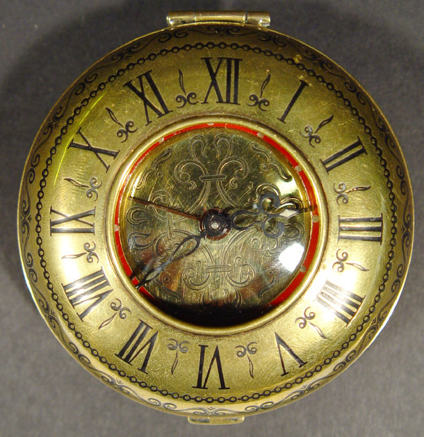 Appraisal: Travelling alarm clock in a bun shaped brass case with