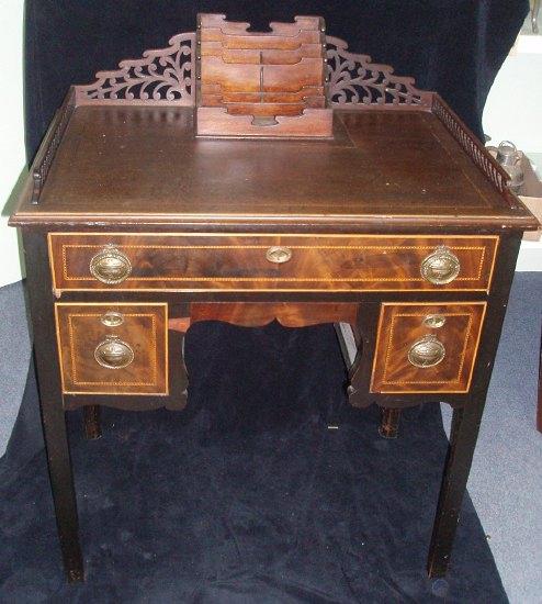 Appraisal: A late th Century kneehole writing table the top with