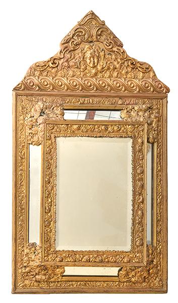 Appraisal: AN EMBOSSED BRASS MOUNTED CUSHION FRONT WALL MIRROR with a