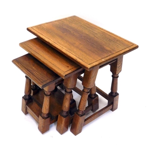 Appraisal: A nest of three Titchmarsh Goodwin style oak tables on