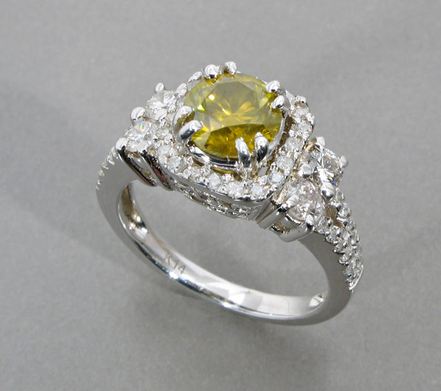 Appraisal: CANARY DIAMOND DIAMOND AND FOURTEEN KARAT WHITE GOLD RING centering