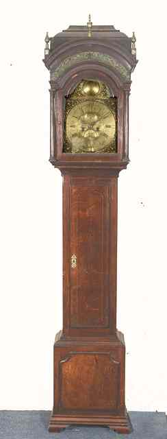 Appraisal: AN OAK EIGHT DAY LONG CASE CLOCK the arched brass