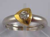 Appraisal: A two colour carat gold diamond solitaire ring the round