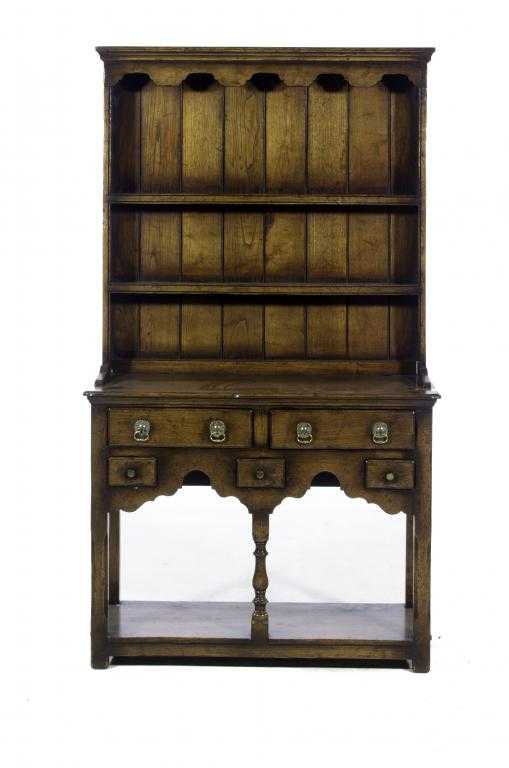 Appraisal: AN OAK DRESSER the boarded rack with shaped canopy the