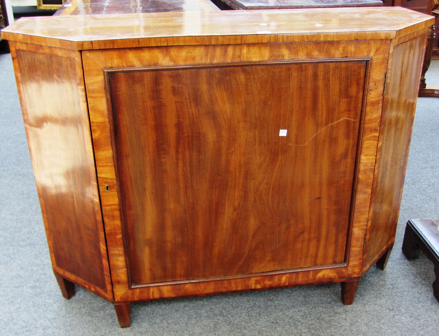 Appraisal: A mahogany and satinwood side cabinet of canted rectangular form