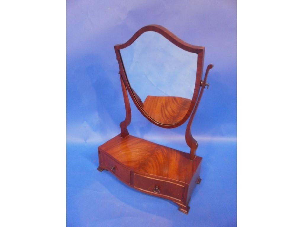 Appraisal: A reproduction mahogany thC style toilet mirror the shield shape