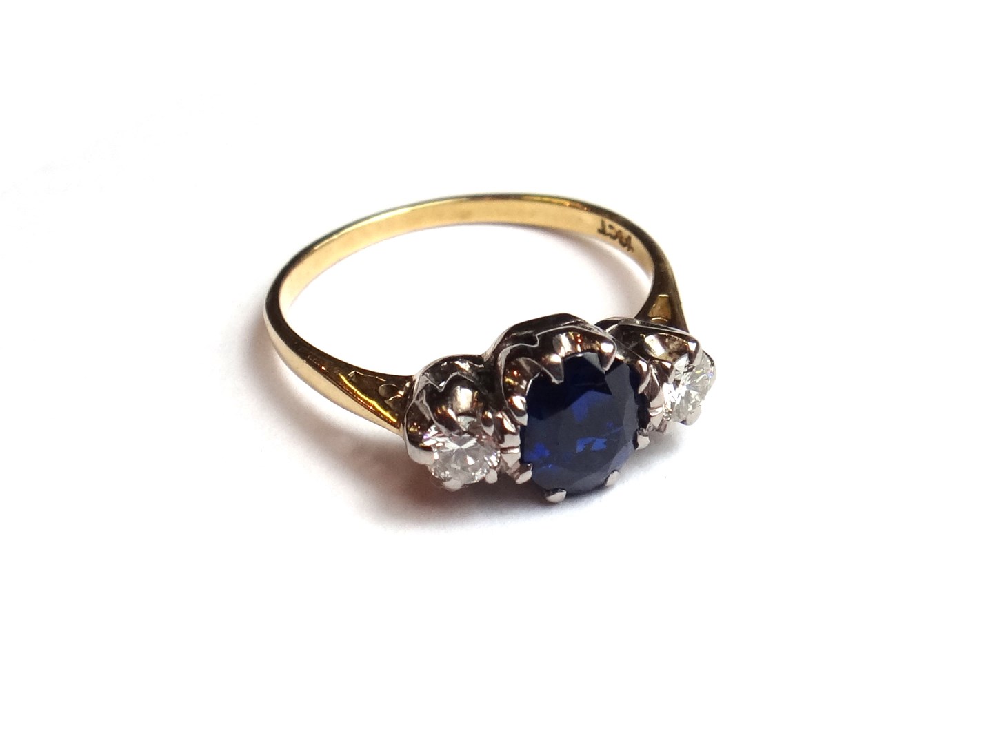 Appraisal: A gold sapphire and diamond set three stone ring claw