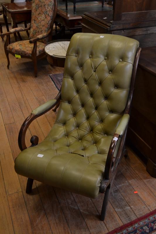 Appraisal: A FRENCH BUTTON-BACK ARMCHAIR IN OLIVE LEATHER TWO BUTTONS MISSING