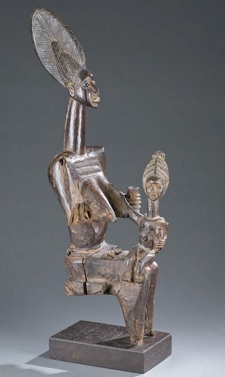 Appraisal: Seated maternity figure A seated maternity figure Nigeria Yoruba th