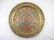 Appraisal: An Islamic brass dish with Islamic teachings in copper and