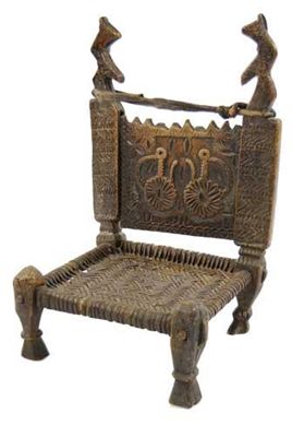 Appraisal: An African low chair the carved back panel with two