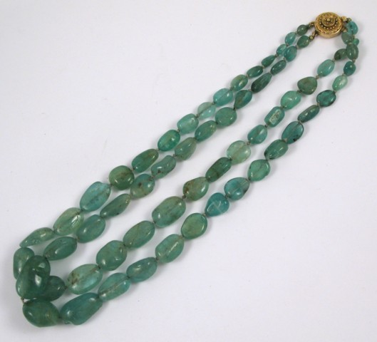 Appraisal: DOUBLE STRAND EMERALD BEADED NECKLACE strung with emeralds coming together