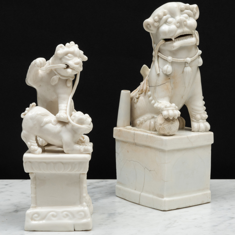 Appraisal: Blanc de Chine Porcelain Group of Two Playful Lions and