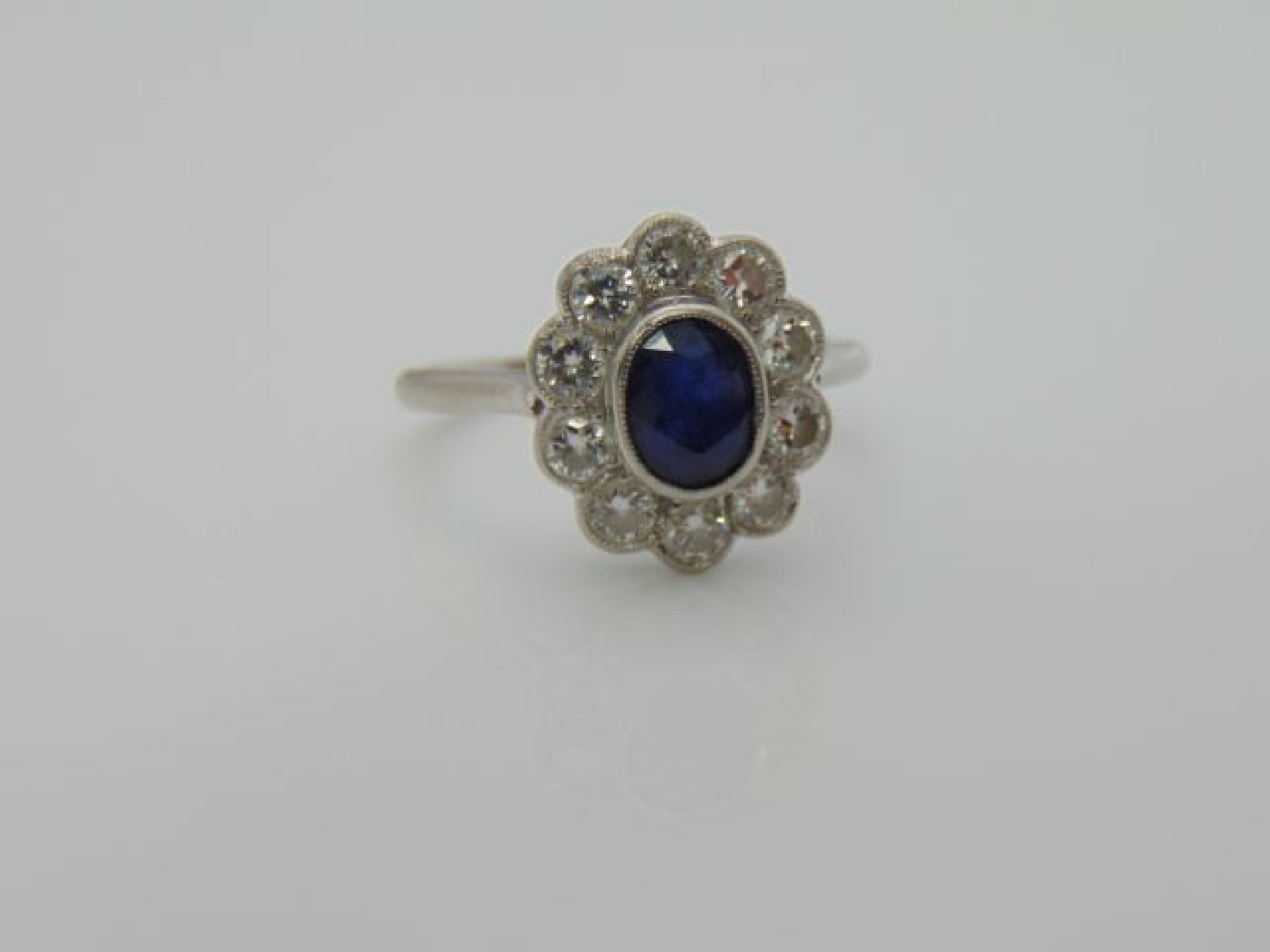 Appraisal: A sapphire and diamond ring London centred with an oval