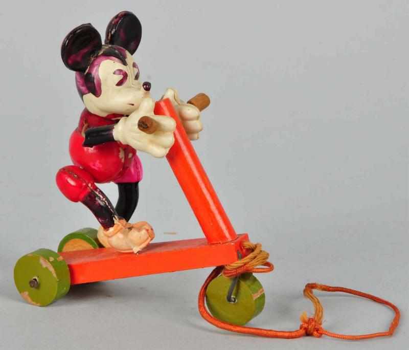 Appraisal: Celluloid Disney Mickey on Wood Scooter Toy Description s Small