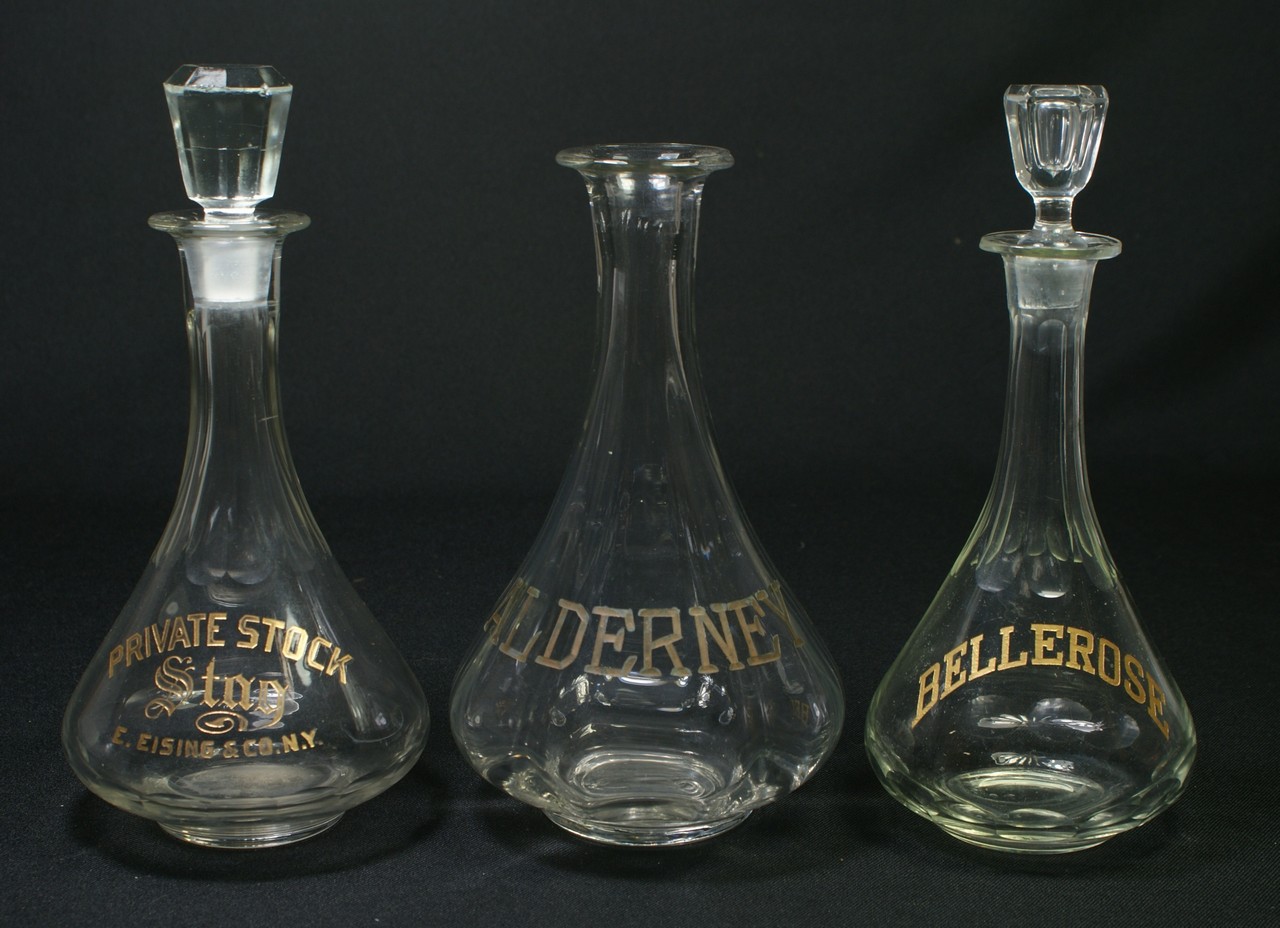 Appraisal: clear glass back bar bottles with gilt etched decoration ALDERNEY