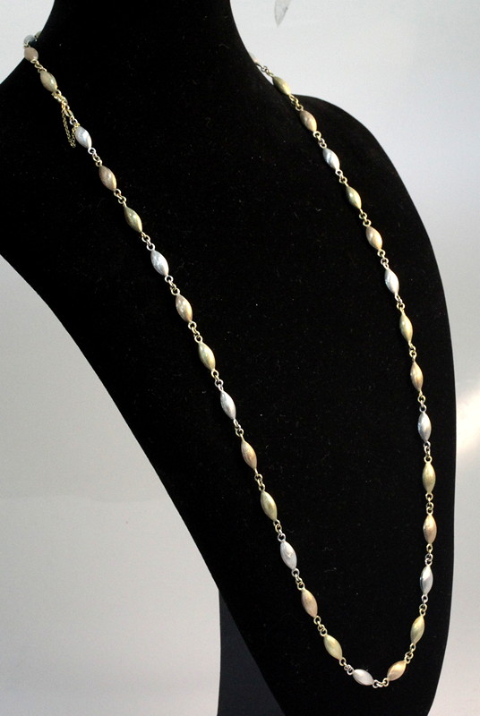 Appraisal: A tri-coloured ct gold necklace of oval textured beads approximately