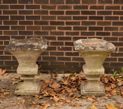 Appraisal: A pair of weathered stone garden vases square with fluted