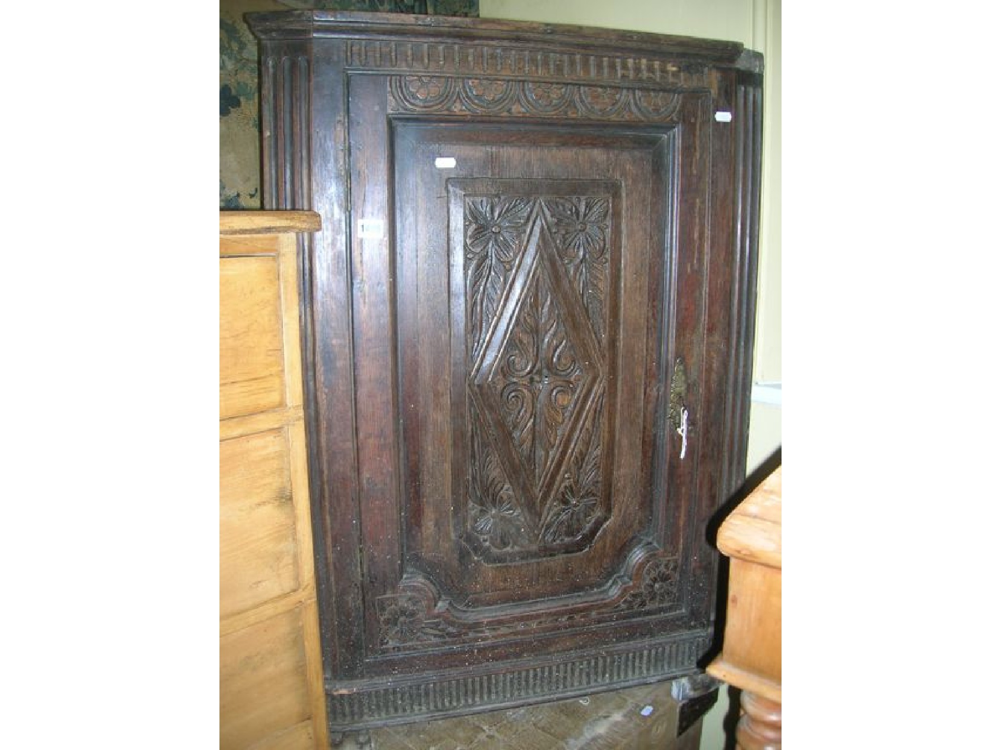 Appraisal: A th century oak freestanding corner cupboard with carved and