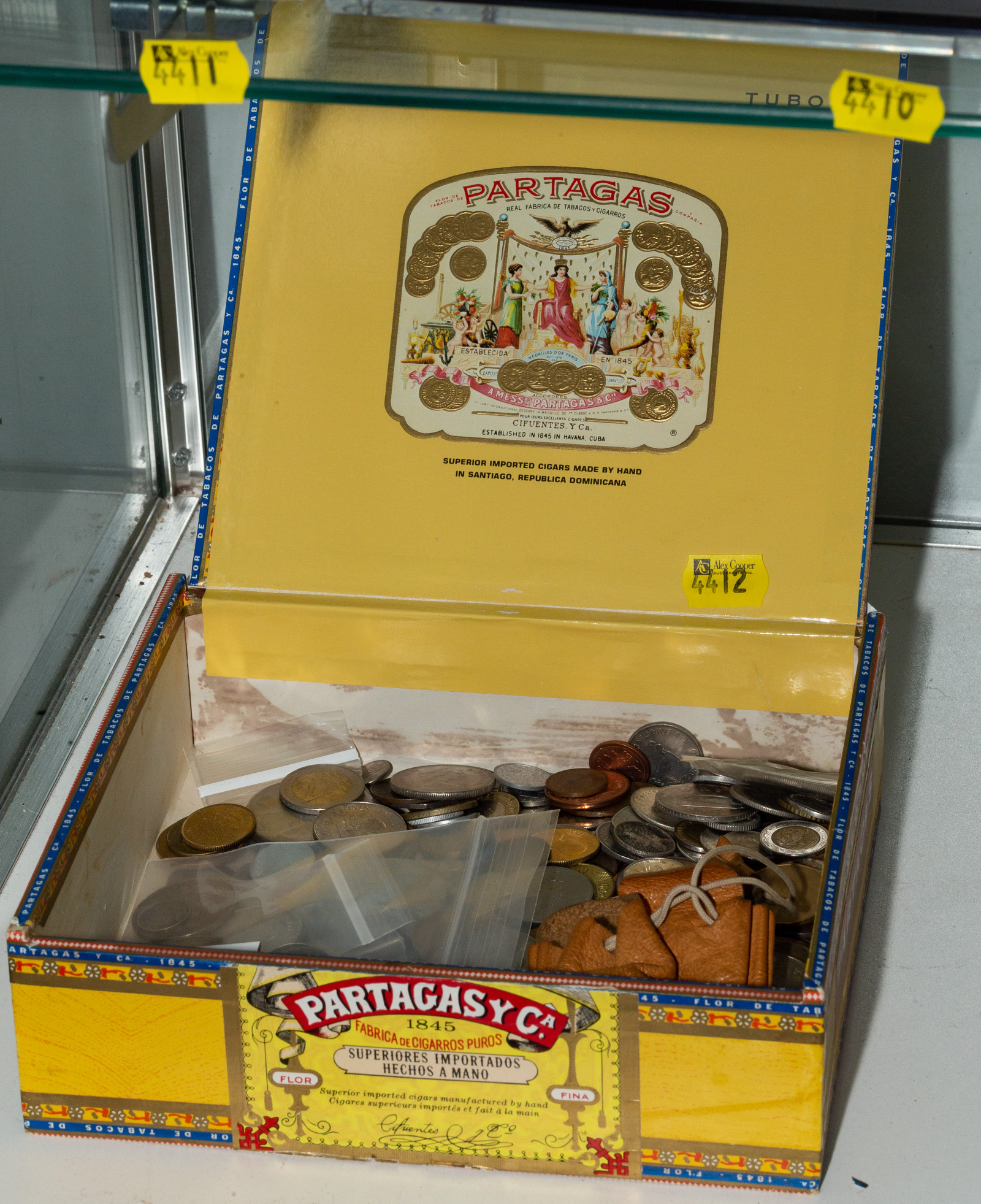 Appraisal: CIGAR BOX WITH WORLD COINS SILVER Partagas Cigar Box from