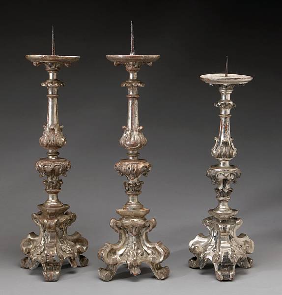 Appraisal: A pair and a single Italian Baroque silvered giltwood pricket