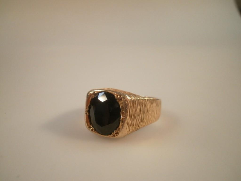 Appraisal: A heavy signet ring set with a very dark sapphire