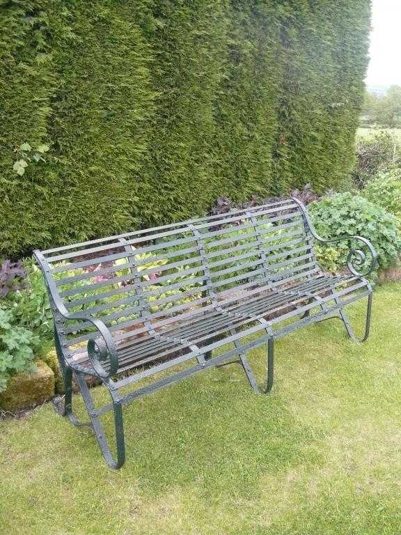 Appraisal: Pair of th Century wrought iron Garden Seats with roll