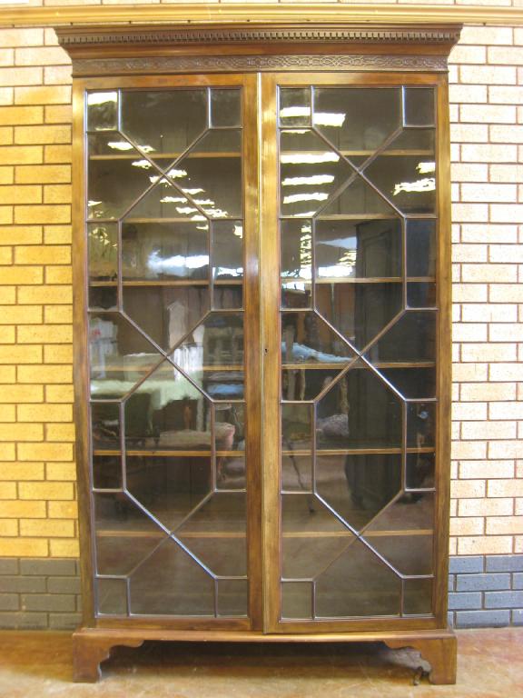 Appraisal: A th Century mahogany glazed Bookcase having dentil cornice above