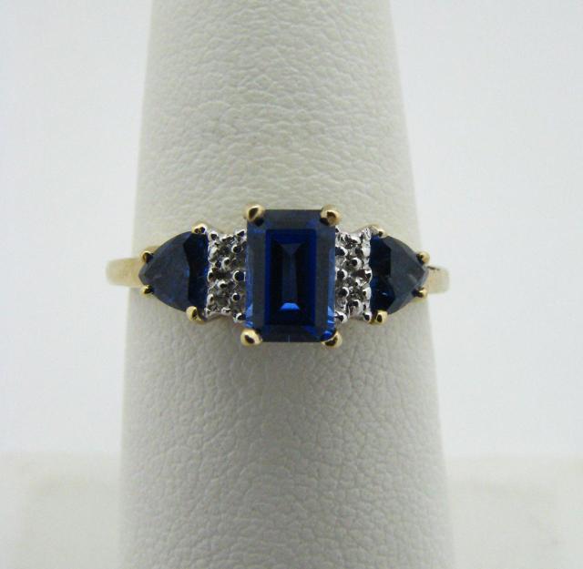 Appraisal: K yellow gold ring with rectangular and trillion-cut created tanzanites