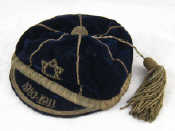 Appraisal: Judaica A peaked blue velvet cap with silver braid and