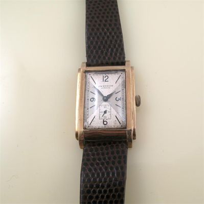 Appraisal: A gold rectangular wristwatch by J W Benson with stepped