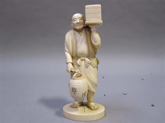 Appraisal: JAPANESE IVORY OKIMONO OF ROBED ELDER th C Holding a