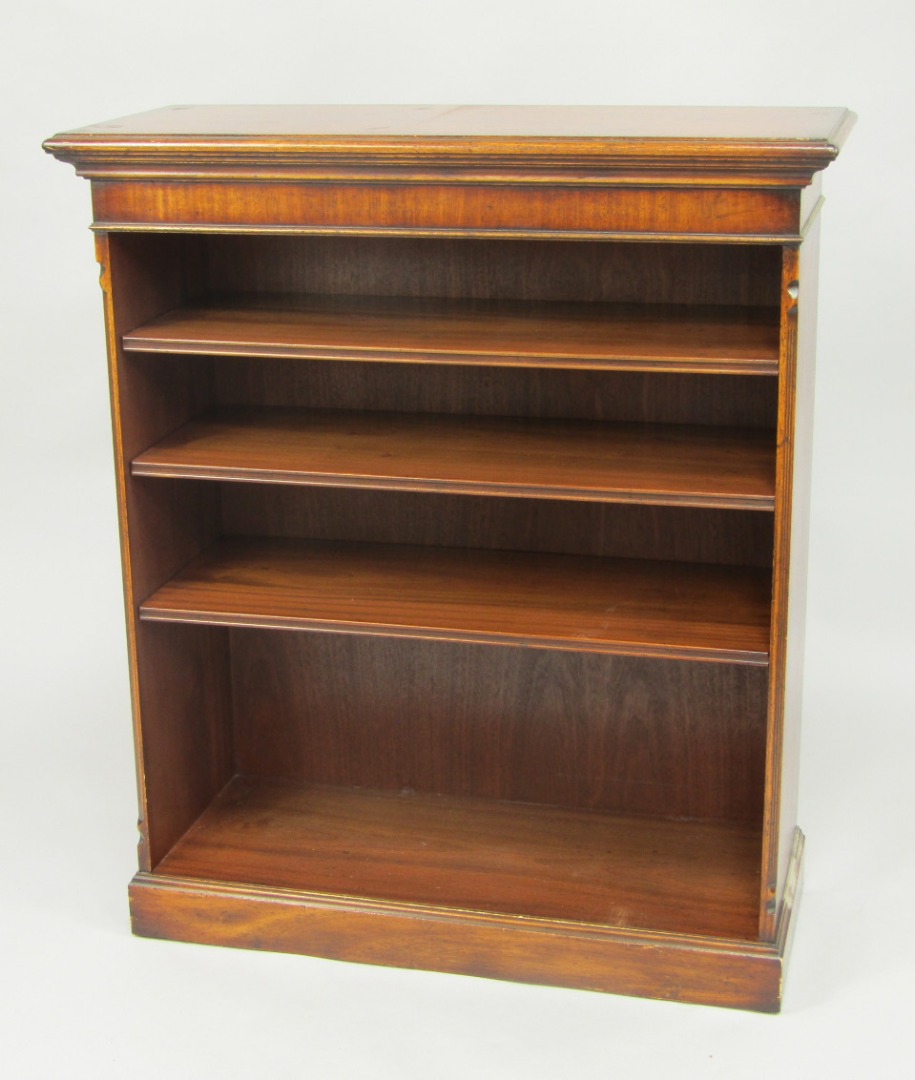 Appraisal: A mahogany open bookcase of three shelves raised on a