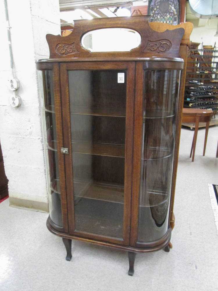 Appraisal: AN OAK AND CURVED GLASS CHINA CABINET Tull Gibbs Fine