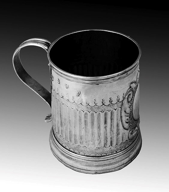 Appraisal: A QUEEN ANNE SILVER TANKARD with fluted sides chased armorial