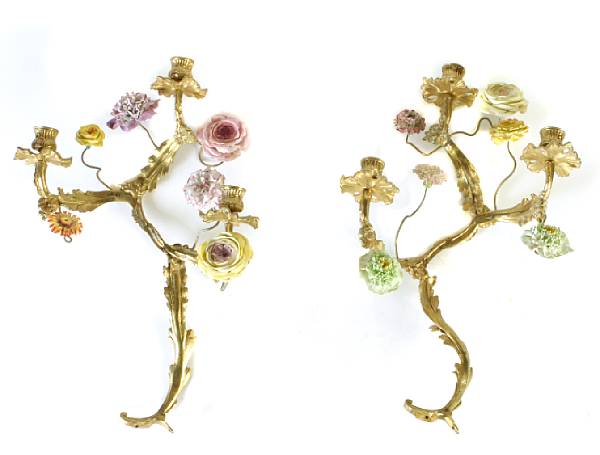 Appraisal: A pair of gilt metal porcelain encrusted three-light wall sconces